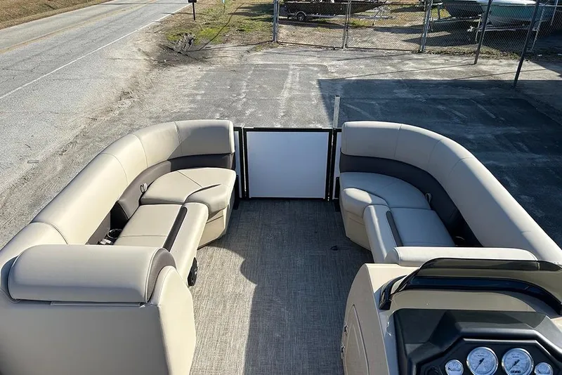 Slide: The Image of 2026 Bentley Pontoons Legacy 223 Swingback interior with beige seating and dashboard view. - 17