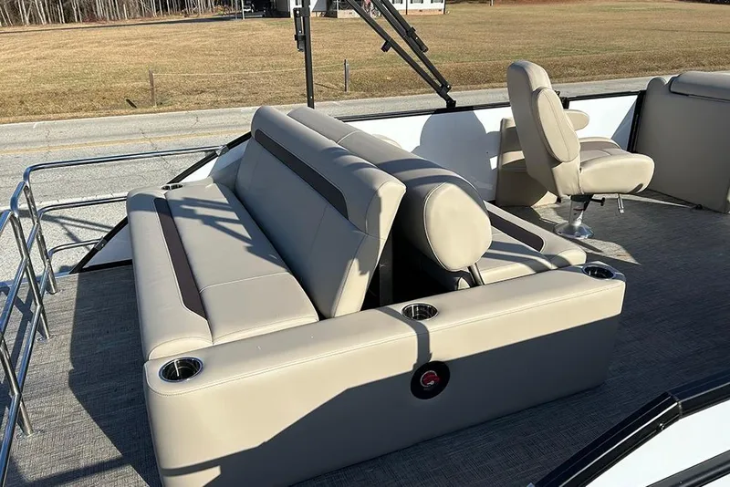 Slide: The Image of 2026 Bentley Pontoons Legacy 223 Swingback with beige seating and cup holders. - 23