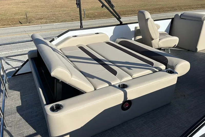 Slide: The Image of 2026 Bentley Pontoons Legacy 223 Swingback with luxurious seating and cup holders. - 25