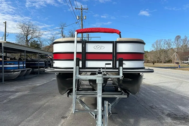Slide: The Image of 2026 Bentley Pontoons Legacy 223 Swingback on trailer, parked outdoors under blue sky. - 3