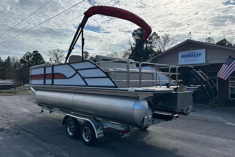 Slide: The Image of 2026 Bentley Pontoons Legacy 223 Swingback on trailer, parked outside dealership. - 6