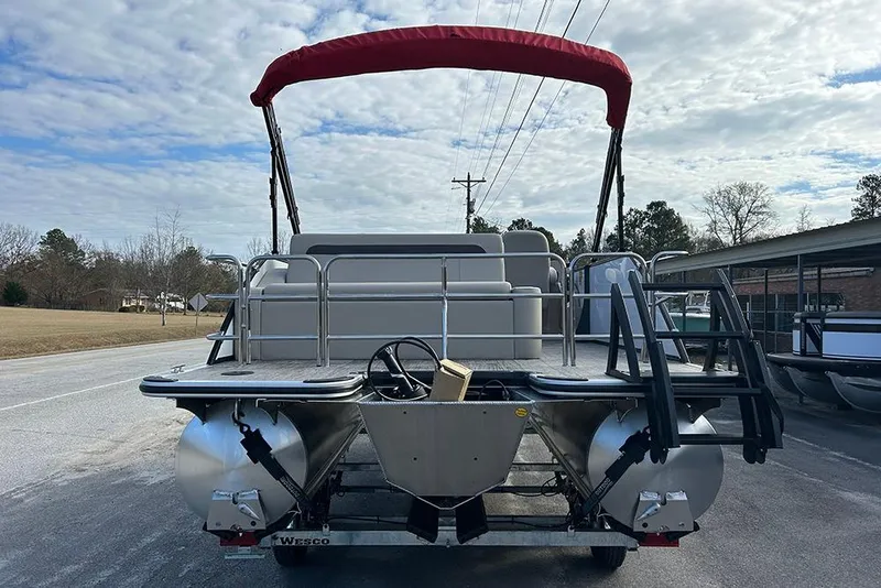 Slide: The Image of 2026 Bentley Pontoons Legacy 223 Swingback with red canopy on a trailer. - 7