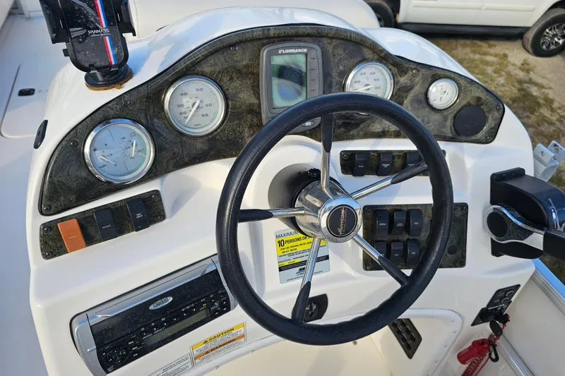 Slide: The Image of 2005 Hurricane FunDeck 218 RE OB boat dashboard with steering wheel and gauges. - 14
