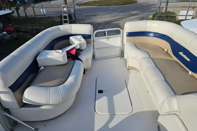 Slide: The Image of 2005 Hurricane FunDeck 218 RE OB boat interior with cushioned seating and cup holders. - 19