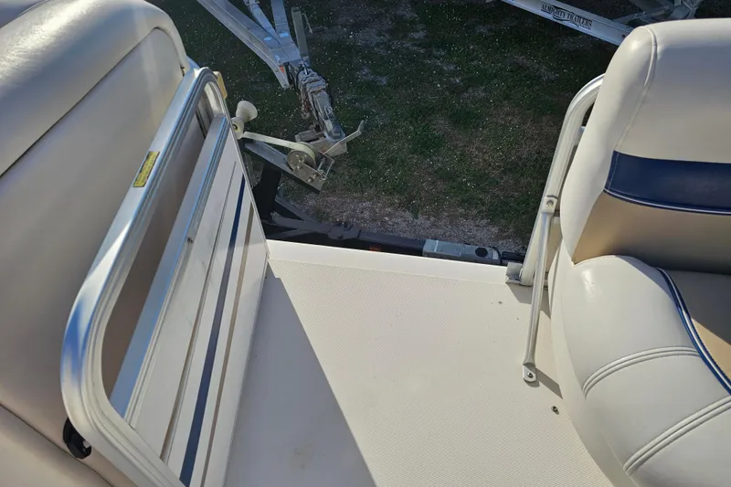 Slide: The Image of 2005 Hurricane FunDeck 218 RE OB boat interior with seating and railing. - 21