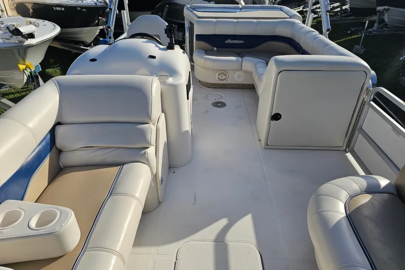 Slide: The Image of 2005 Hurricane FunDeck 218 RE OB boat interior with white and blue seating. - 22