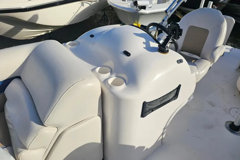 Slide: The Image of 2005 Hurricane FunDeck 218 RE OB boat interior with steering console and seating. - 25