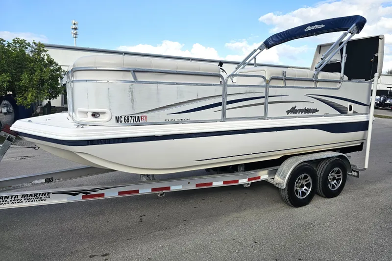 Slide: The Image of 2005 Hurricane FunDeck 218 RE OB boat on trailer, parked outdoors. - 4