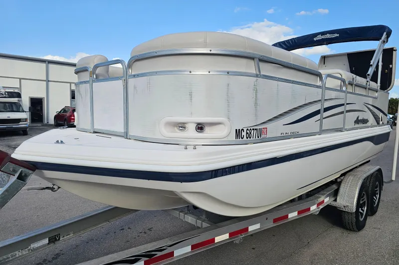 Slide: The Image of 2005 Hurricane FunDeck 218 RE OB boat on trailer, white with blue accents. - 5