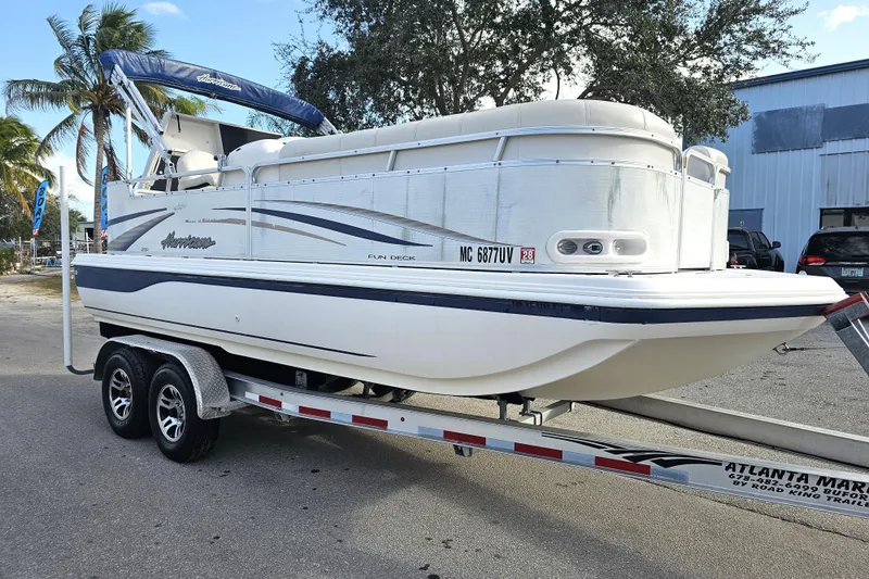 Slide: The Image of 2005 Hurricane FunDeck 218 RE OB boat on trailer, parked outdoors. - 6
