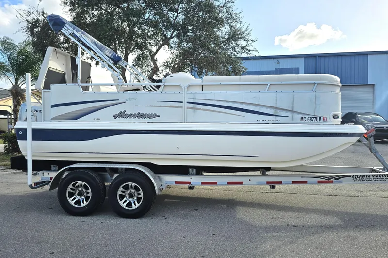 Slide: The Image of 2005 Hurricane FunDeck 218 RE OB boat on trailer, parked outdoors. - 8