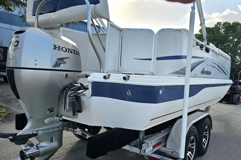 Slide: The Image of 2005 Hurricane FunDeck 218 RE OB boat with Honda outboard motor on trailer. - 9