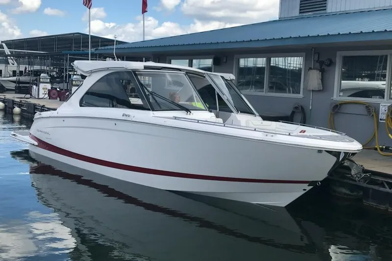 The Image of 2022 Regal LS36 boat docked at marina under blue sky. - 0