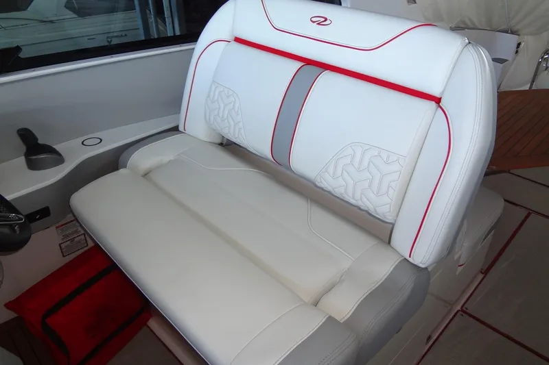 Slide: The Image of Luxurious white seating on 2022 Regal LS36 boat with red accents. - 14