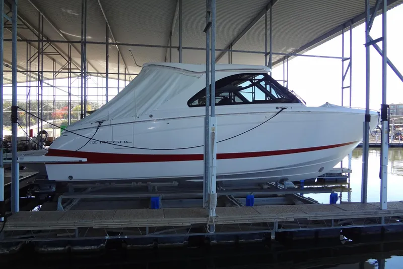 Slide: The Image of 2022 Regal LS36 boat docked in a covered marina, side view. - 2