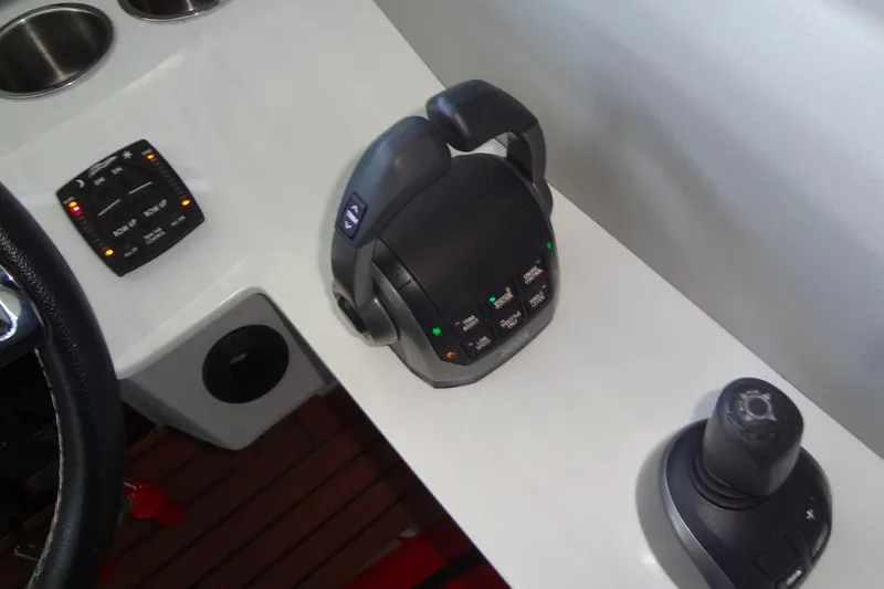 Slide: The Image of Control panel of a 2022 Regal LS36 boat with joystick and throttle. - 20