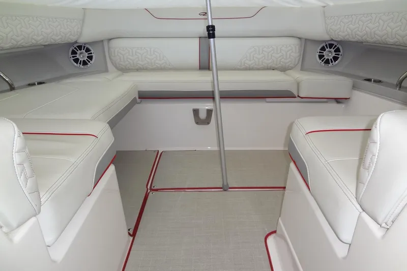 Slide: The Image of 2022 Regal LS36 boat interior with white seating and red accents. - 21