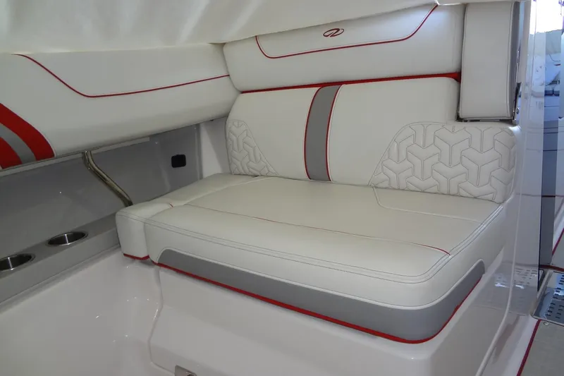 Slide: The Image of 2022 Regal LS36 boat interior with white and red cushioned seating. - 23