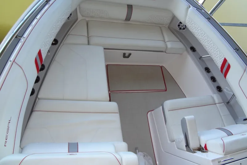 Slide: The Image of Luxurious interior of 2022 Regal LS36 boat with white seating and red accents. - 24