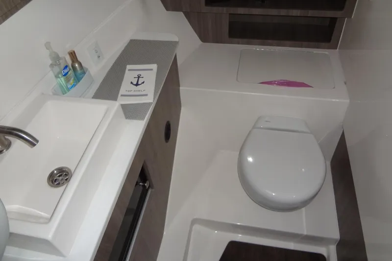 Slide: The Image of 2022 Regal LS36 boat bathroom with sink, toilet, and toiletries. - 29