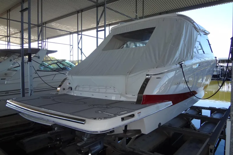 Slide: The Image of 2022 Regal LS36 boat docked in a covered marina, rear view. - 3