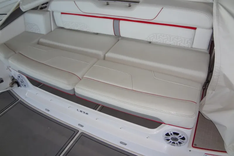 Slide: The Image of 2022 Regal LS36 boat interior with white seating and red accents. - 31