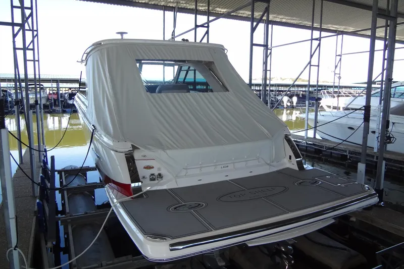 Slide: The Image of 2022 Regal LS36 boat docked in a marina, rear view with covered deck. - 4