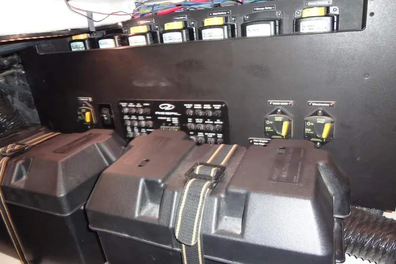 Slide: The Image of Electrical panel of 2022 Regal LS36 boat with battery compartments and switches. - 41