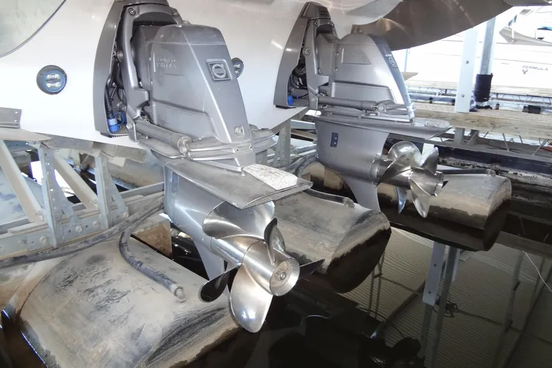 Slide: The Image of 2022 Regal LS36 boat with dual propellers in a marina setting. - 44