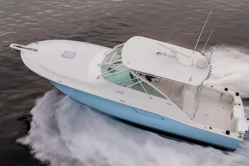 Slide: The Image of 2006 Cabo 40 Express boat cruising on water, aerial view. - 11