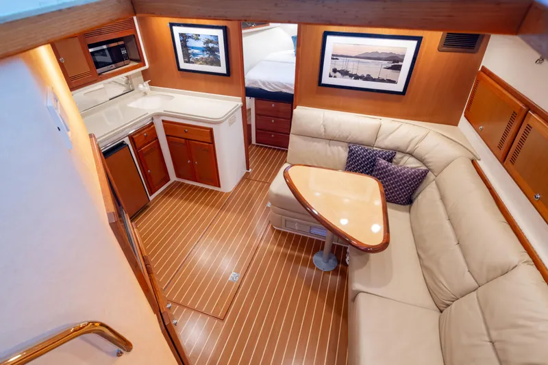 Slide: The Image of Luxurious 2006 Cabo 40 Express yacht interior with kitchen and seating area. - 12