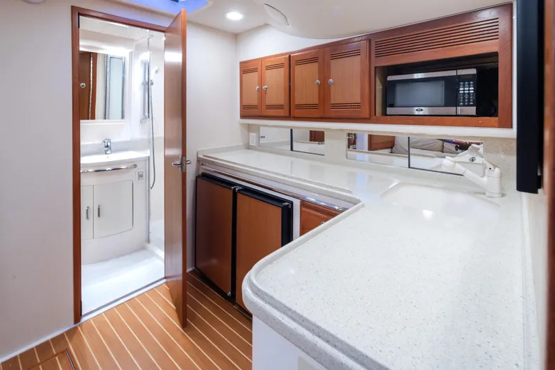 Slide: The Image of 2006 Cabo 40 Express yacht interior with kitchenette and bathroom. - 15