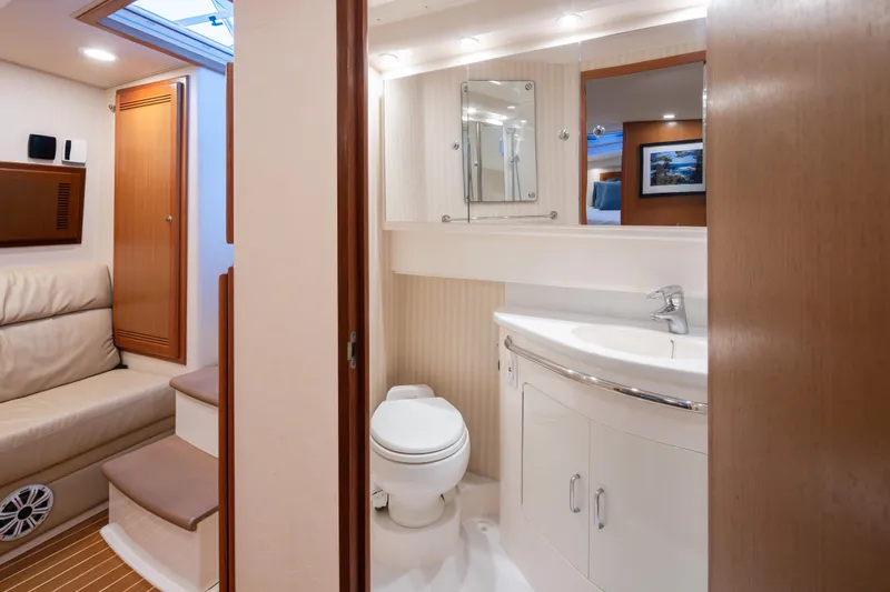 Slide: The Image of Luxurious 2006 Cabo 40 Express yacht interior with modern bathroom and seating area. - 19