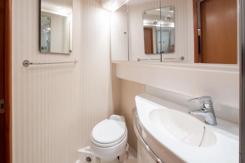 Slide: The Image of Luxurious bathroom in 2006 Cabo 40 Express yacht with modern fixtures and elegant design. - 20