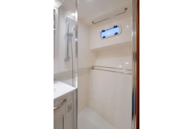 Slide: The Image of Compact shower area in 2006 Cabo 40 Express yacht bathroom. - 21