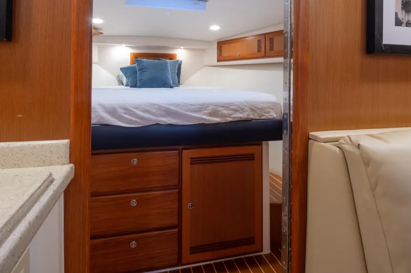 Slide: The Image of Interior cabin of 2006 Cabo 40 Express yacht with bed and wooden cabinetry. - 22