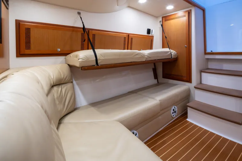 Slide: The Image of Interior of 2006 Cabo 40 Express yacht with beige seating and wooden accents. - 26