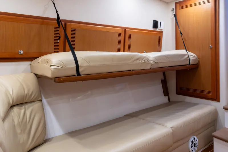 Slide: The Image of Interior of 2006 Cabo 40 Express yacht with beige leather seating and wooden cabinetry. - 27