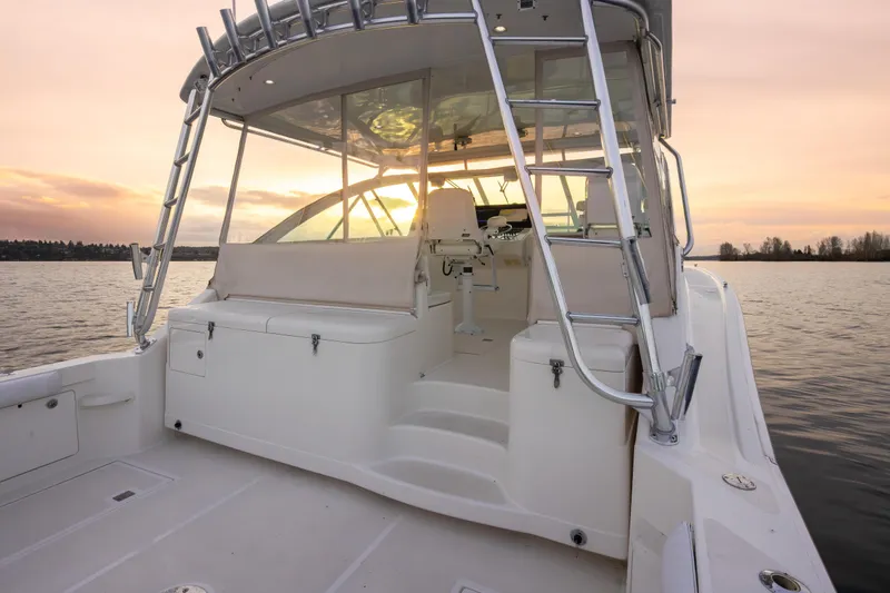 Slide: The Image of 2006 Cabo 40 Express boat at sunset on calm waters. - 28