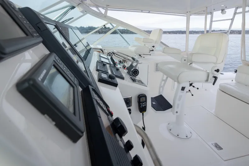 Slide: The Image of Interior of 2006 Cabo 40 Express yacht with modern navigation equipment and white seating. - 30