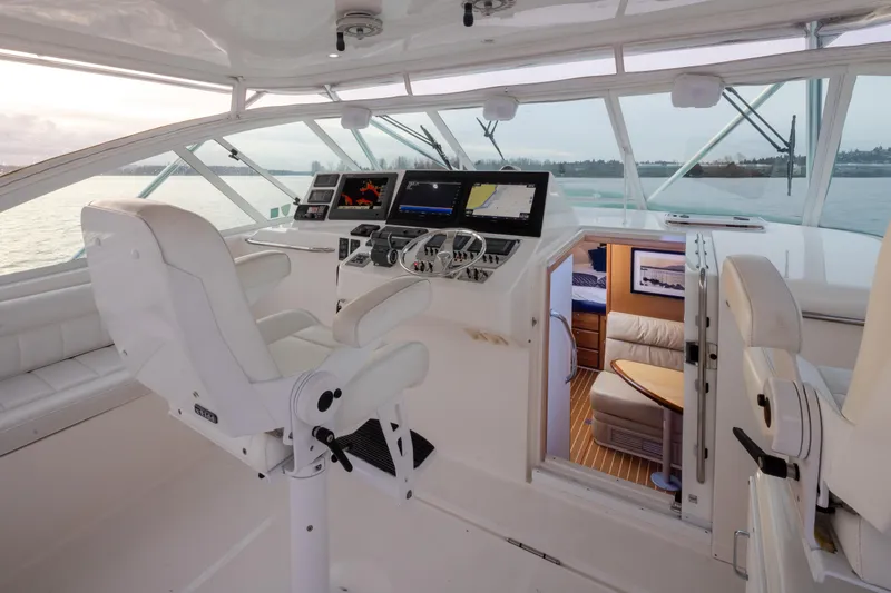 Slide: The Image of Interior of 2006 Cabo 40 Express yacht with modern navigation equipment and luxurious seating. - 33