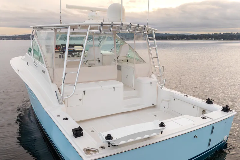 Slide: The Image of 2006 Cabo 40 Express boat on calm water, featuring spacious deck and sleek design. - 4