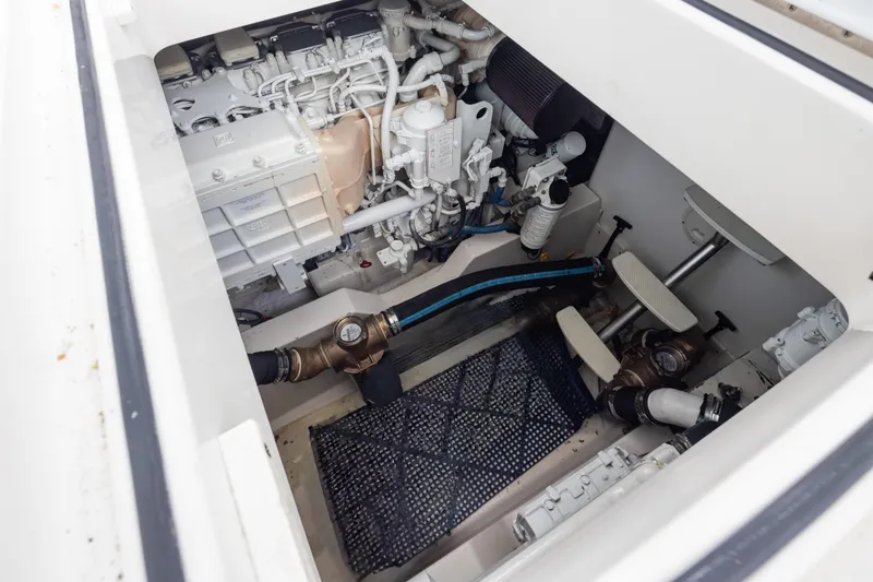 Slide: The Image of Engine compartment of 2006 Cabo 40 Express boat, showcasing mechanical components and systems. - 40