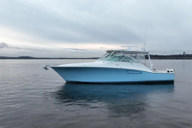 Slide: The Image of 2006 Cabo 40 Express Sportfish boat on calm water under cloudy sky. - 43