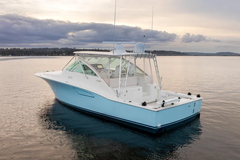 Slide: The Image of 2006 Cabo 40 Express boat on calm water at sunset. - 6