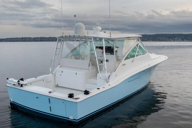 Slide: The Image of 2006 Cabo 40 Express boat on calm water under cloudy sky. - 7