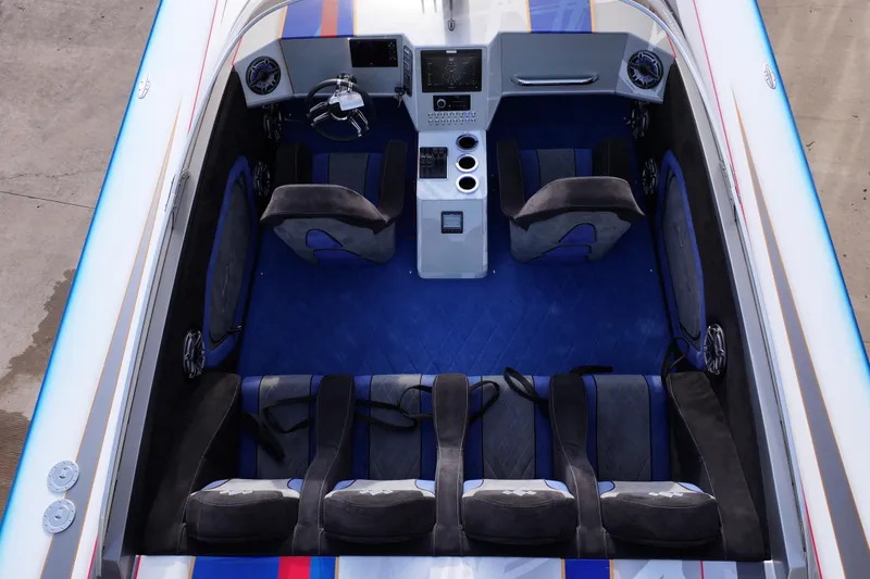 Slide: The Image of Interior of a 2016 Skater 388 boat with blue and black seating. - 10