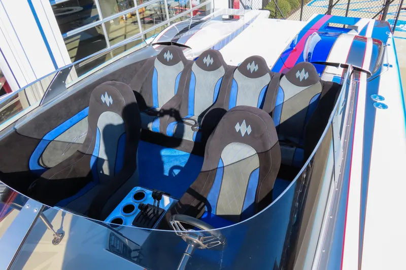 Slide: The Image of Interior of a 2016 Skater 388 speedboat with blue and black seating. - 12