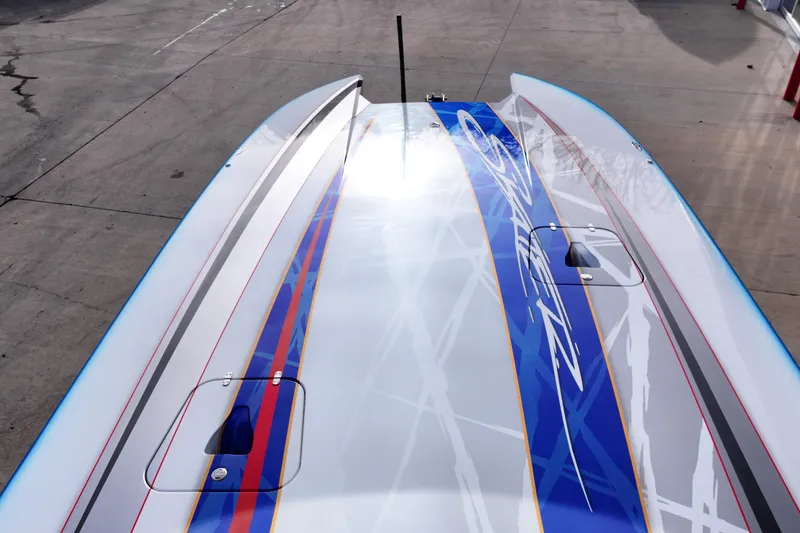 Slide: The Image of 2016 Skater 388 boat with sleek design and vibrant blue graphics on deck. - 8