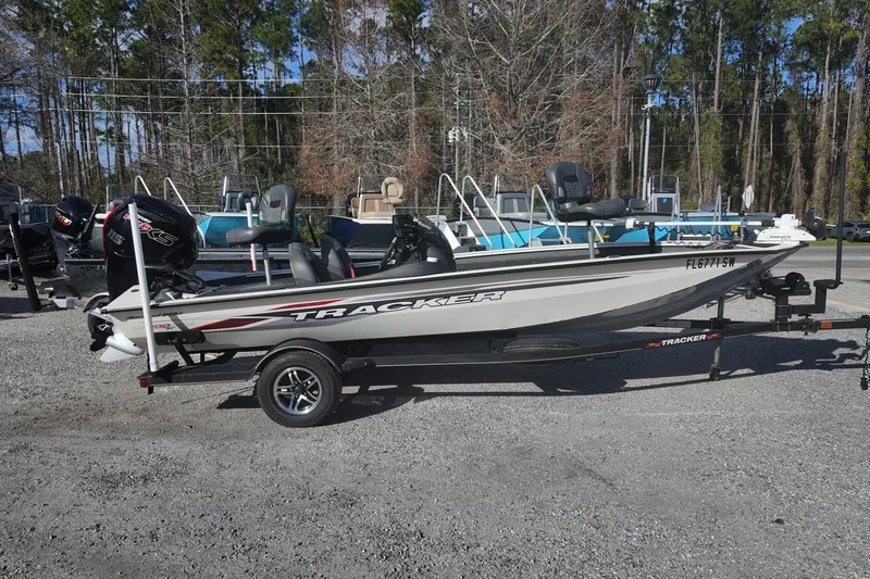 The Image of 2021 Tracker Pro Team 190 TX fishing boat on trailer, parked outdoors. - 0